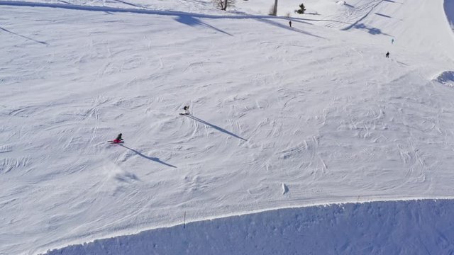 Aerial Shot of Skiers Coming Down the Slope.
Overview of Skiers Going Downhill from Snowy Slope.