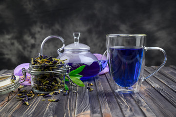Cup and teapot butterfly pea flower blue tea. Healthy detox herbal drink.