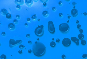  Abstract background from drops of blue paint on a blue background.