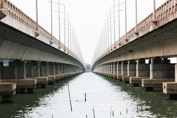 Perspective of concrete Bridge over the Songkhla lake in Thailand