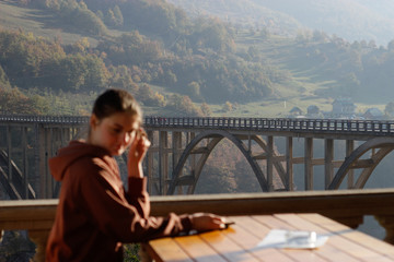 bridge in Montenegro over the Tara river in the background the girl is out of focus