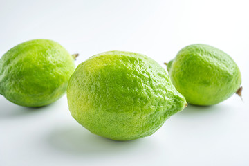 Fresh green lemon on white background