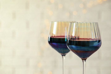 Glasses of red wine on light background, closeup. Space for text