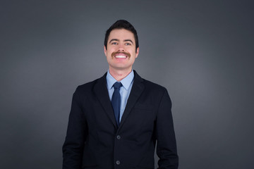 Horizontal portrait of pleasant-looking Caucasian male wearing casual clothes looking happily to the camera.