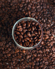 Coffee beans and a glass tumbler