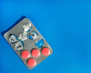 Pharmaceutical preparation. Open blister with tablets on a blue background. Medicine.