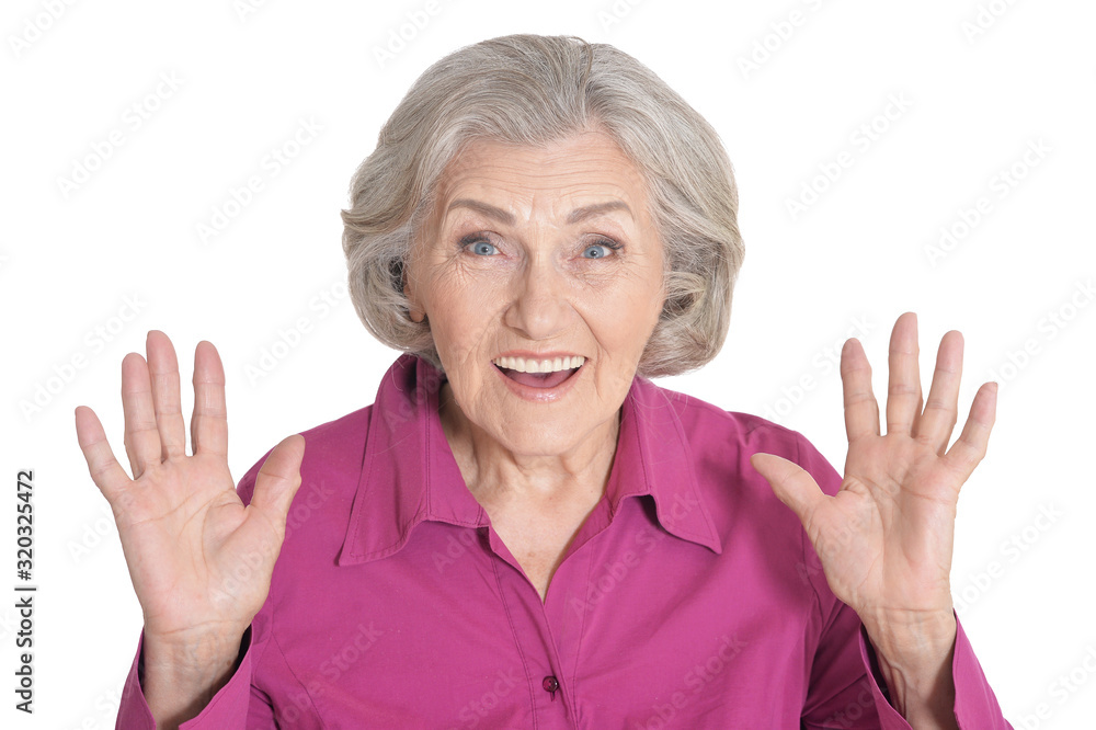 Wall mural Surprised senior woman posing against white background