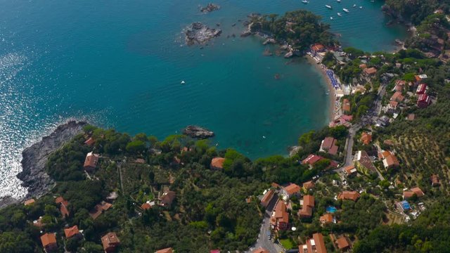 Aerial reveal shot of amazing, vibrant italian coast and Porto Venere natural park