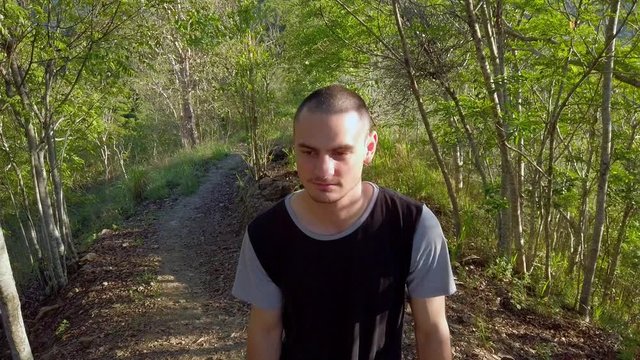 A mand wlaking on the rainforest trails of Cairns, Queensland, Australia -  close up slo motion