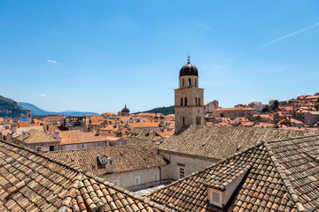 Fototapeta premium A photograph showing the UNESCO World Heritage Site Dubrovnik, Croatia. A number of terracotta roof tops and historical buildings are positioned within the walled city of Dubrovnik. 