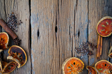 Cinnamon sticks ,anise stars and dried quince on old wooden plates.