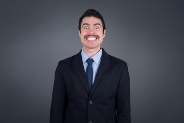 Young handsome businessman having broad white smile being excited to meet Friends and go out to have a good day.