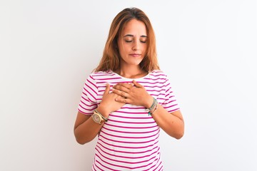 Young redhead woman wearing striped casual t-shirt stading over white isolated background smiling...