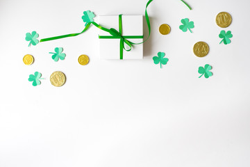Gift box with a green bow, happy Shamrock, chocolate coins-St. Patrick's day background