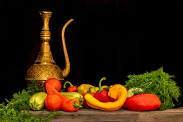 Fototapeta na wymiar Still life of fresh vegetables on a black background. Peppers, zucchini, tomatoes, dill.