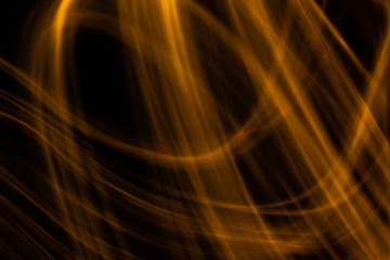 Pomarańczowe, złote linie światła na czarnym tle