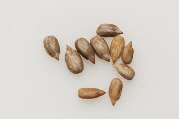 Peeled sunflower seeds on a white background