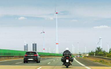 Motorbike and car wind mils on road in Switzerland