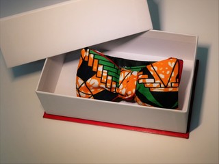 Bow tie in colorful African wax in white box on white background