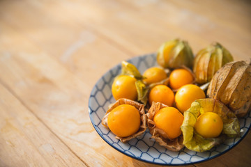 Gape gooseberries and natural background. Cape gooseberry on wooden table. Cape Gooseberry from top view.  fresh cape gooseberry background , selective focus .