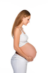 Pregnant woman touching her belly isolated on white.