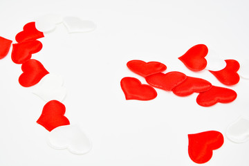 Red and white fabric hearts on a white background. Theme for Valentine's Day and holidays