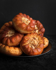 Fried peremyachi, belyashi, pies on a black background. Traditional Russian pies. Russian, Bashkir and Tatar cuisines. Close up.