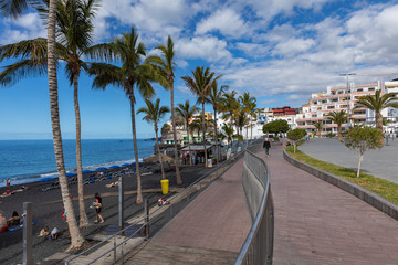 Naklejka premium Puerto Naos beach an sunbathing people at beach with black lava sand at La Palma, Canary Island, Spain.