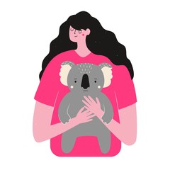Long hair woman hugs koala. Rescue animals from fires in Australia.