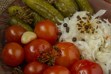 Pickles for a festive table. Winter dish of homemade cucumbers, tomatoes and cabbage