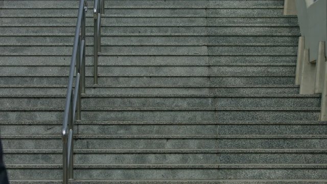 A Beautiful Young Red-haired Woman Climbs The Great Concrete City Stairs. Shot From Behind In Slow Motion, 4K,UHD