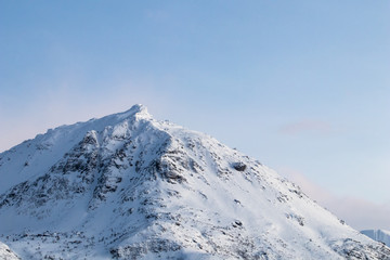 Fototapeta na wymiar Mountain silhouette profile in arctic landscape with snow and ice. Snowy mountain on a blue sky and clouds, profile of a mountain with snow and ice. Winter landscape