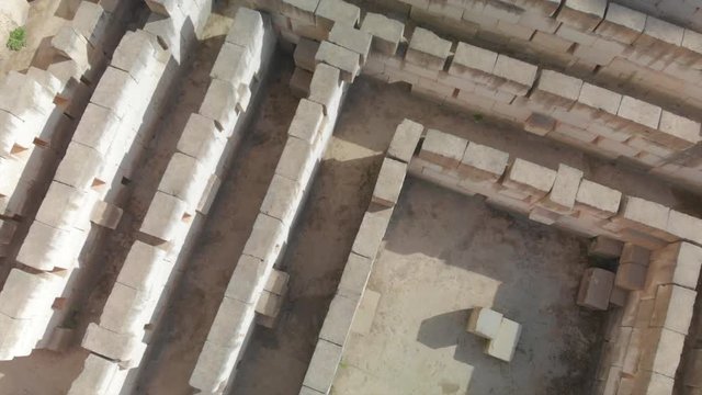 drone footage of  Lithica Ciutadella in menorca spain tilting up the historic labyrinth