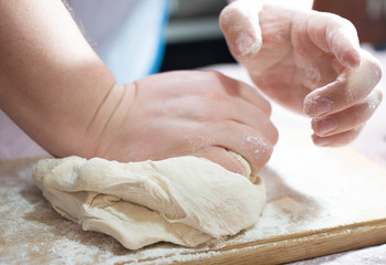 Knead the dough on a wooden board