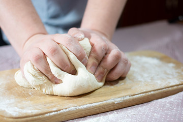 Knead the dough on a wooden board
