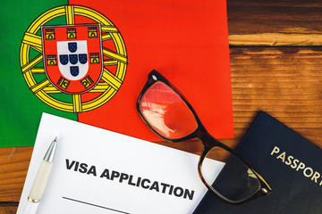Flag of Portugal  , visa application form and passport on table