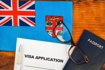 Flag of Fiji , visa application form and passport on table