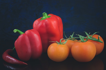 red pepper, red chili pepper and red tomatoes on a beautiful background