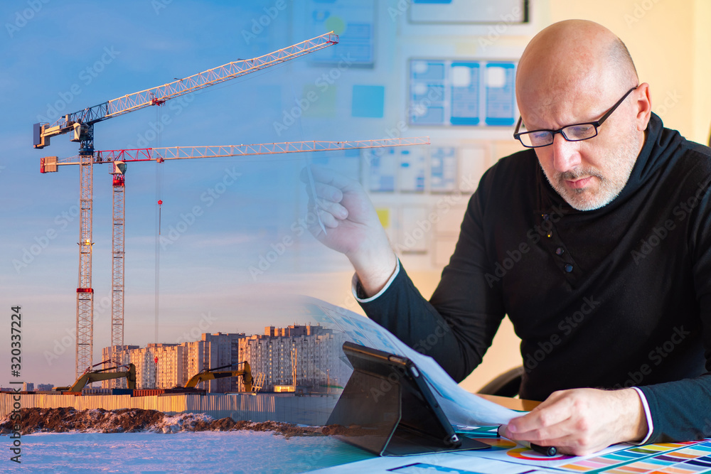 Poster development of urban construction projects. architect at his desk on the background of the construct