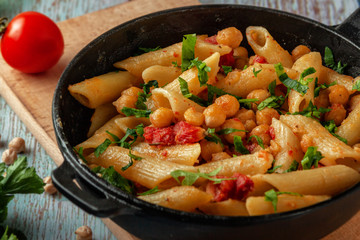 Italian pasta with chickpeas, spices and tomatoes - closeup