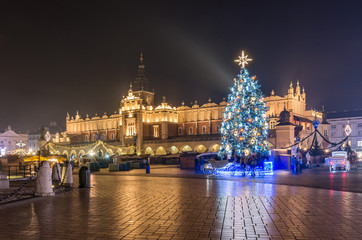 Fototapeta na wymiar Krakow, Poland, Main Square and Cloth Hall in the winter season, during Christmas fairs decorated with Christmas tree.