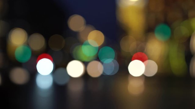 Defocused photography of the lights of the city blurred motion. Traffic on the city street is slow, colorful and bright. Dark background. Lifestyle and beauty concepts.