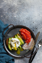 Valentine's day breakfast. Boiled egg sandwich with avocado, coffee, salmon and smoked salmon on a stone concrete tabletop. Top view flat lay background. Copy space.