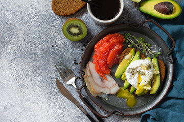 Valentine's day breakfast. Boiled egg sandwich with avocado, coffee, salmon and smoked salmon on a stone concrete tabletop. Top view flat lay background. Copy space.