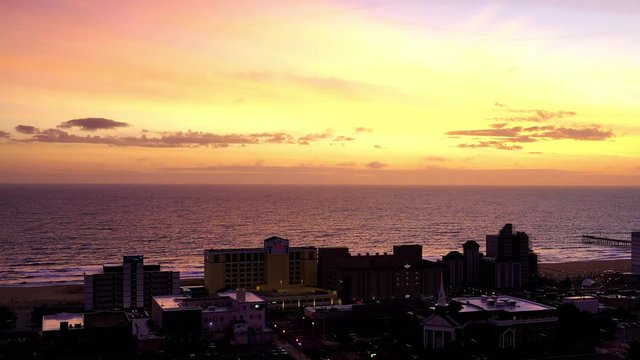 Aerial: Flying Over Virginia Beach Ocean Front during the sunrise