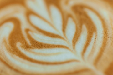 Close up coffee latte art, painting on creamy for background.