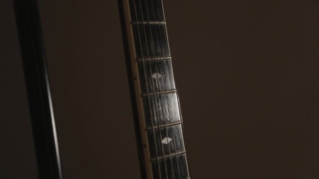 Tilt Up Of Acoustic Guitar From Neck To The Head With Cappo  - Close Up Shot