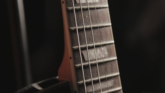 Close Up Of Acoustic Guitar Neck Fingerboard On A Black Background - Close Up Shot