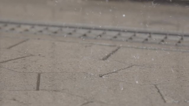 It's raining - drops are falling on cobblestones. A puddle is created - Two- High quality LOG-Footage - Slow motion and close-up