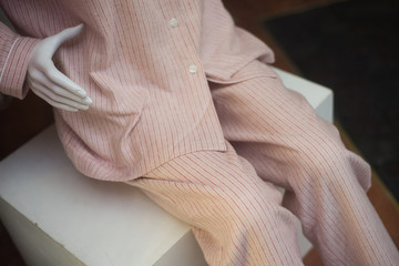 Closeup of beige pajama on mannequin in a fashion store showroom